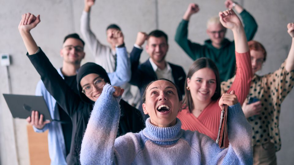 A group of people celebrating and cheering, embracing change and new opportunities.