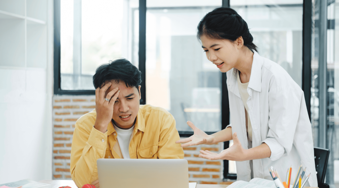 A millennial employee looking confused while discussing with a Gen Z colleague, who is confidently explaining something in a workplace setting.